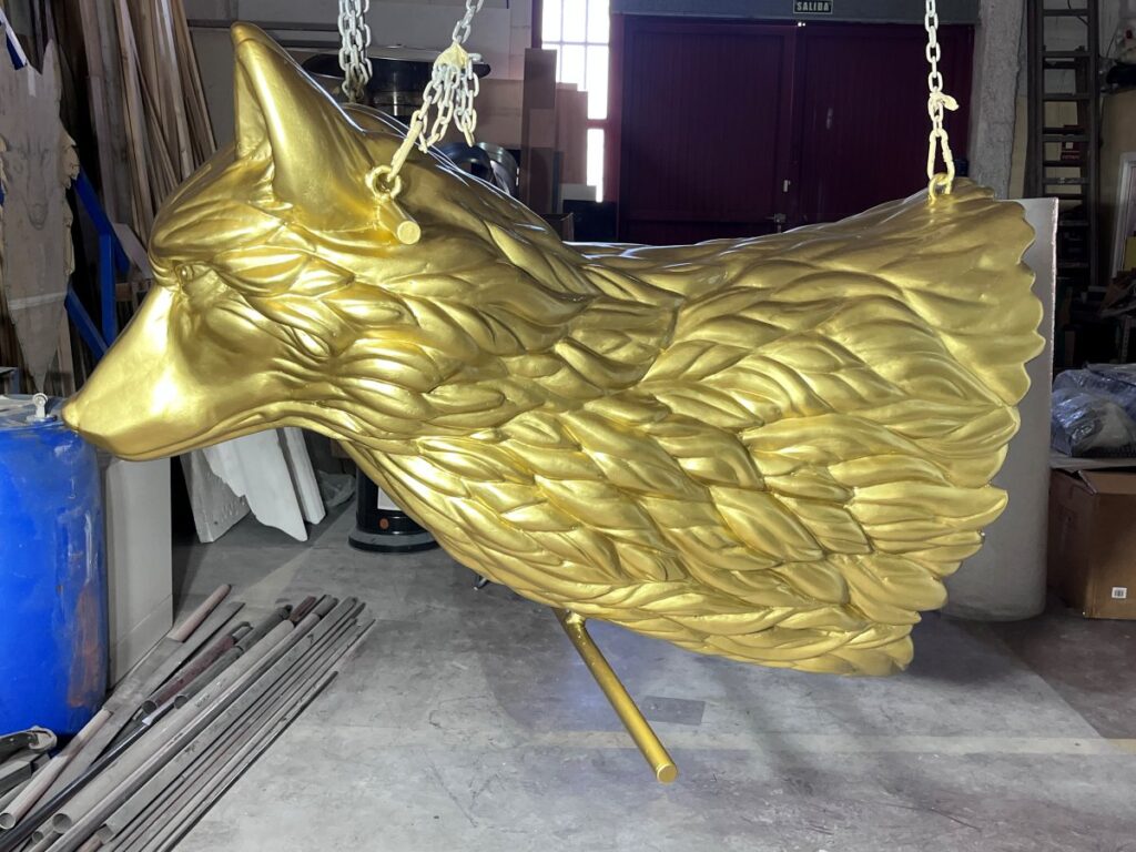 Cabeza de loba dorada de gran tamaño colgada en el taller